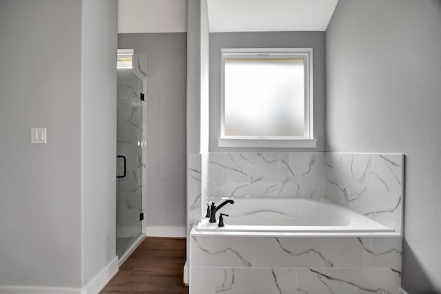 bathroom with wood-type flooring and independent shower and bath