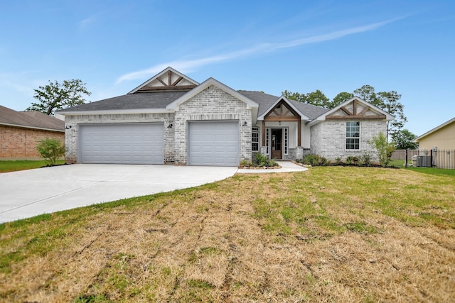 view of front of house with a garage, a front yard, and central air condition unit