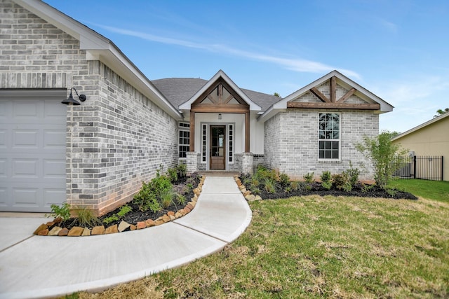 view of front of property featuring a garage and a front lawn