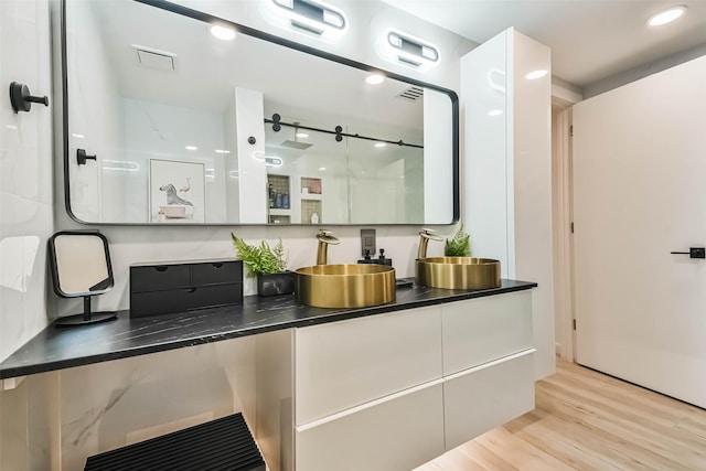 bathroom with vanity and hardwood / wood-style flooring