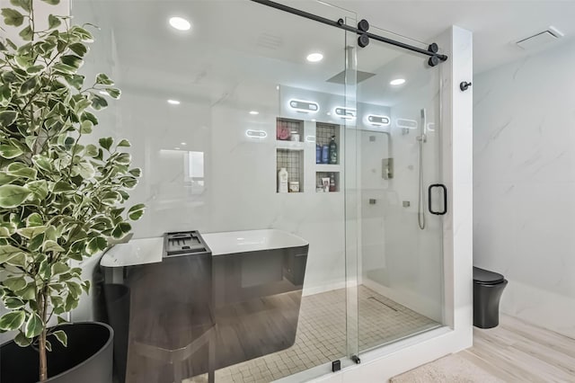 bathroom featuring independent shower and bath, hardwood / wood-style flooring, and tile walls