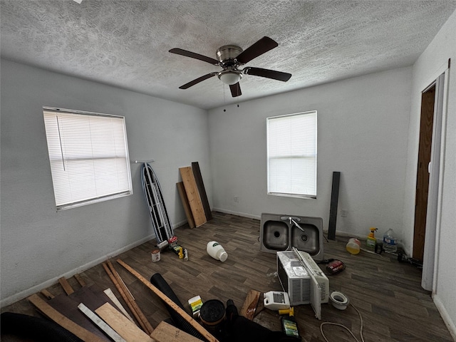 bedroom featuring ceiling fan, dark hardwood / wood-style floors, and a textured ceiling