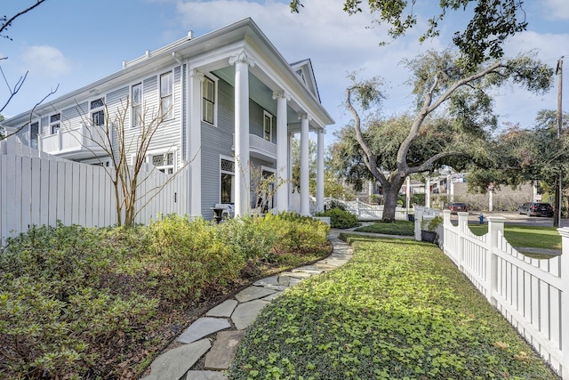 view of side of property with a lawn