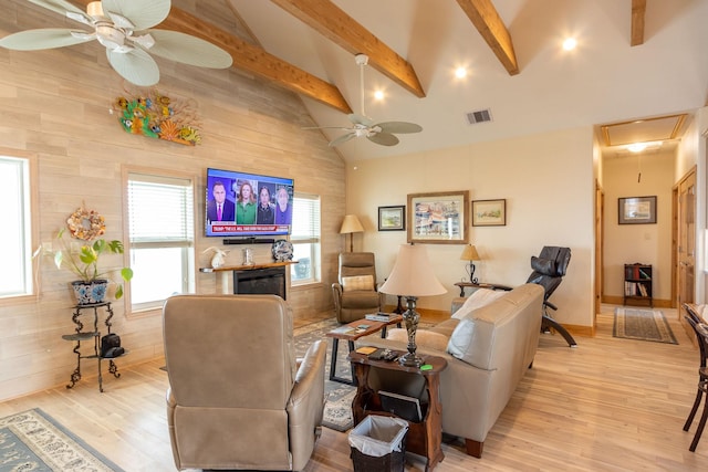 living room featuring beamed ceiling, high vaulted ceiling, ceiling fan, and light hardwood / wood-style flooring