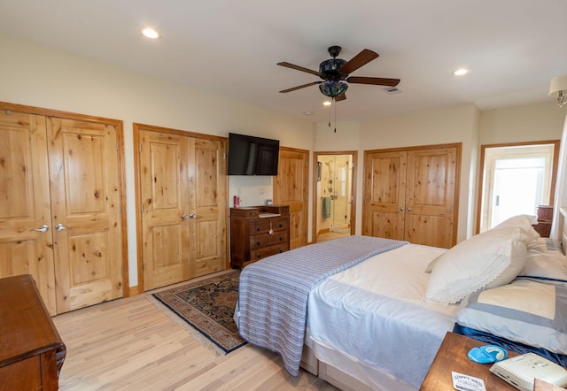 bedroom featuring ensuite bath, ceiling fan, and light wood-type flooring