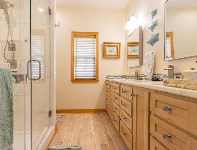 bathroom with vanity, hardwood / wood-style floors, and an enclosed shower