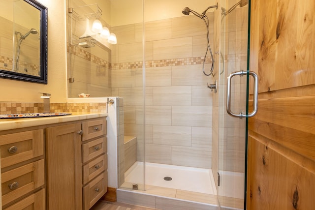 bathroom featuring walk in shower and vanity