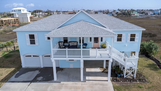 back of property featuring a garage and covered porch