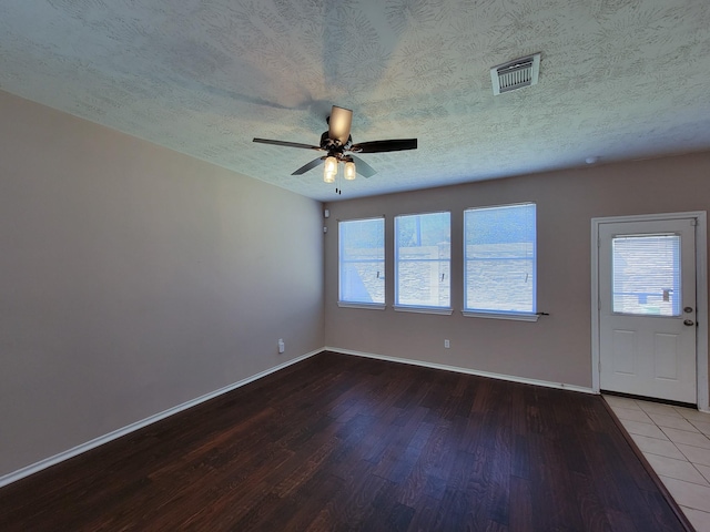 interior space featuring wood-type flooring, a textured ceiling, and ceiling fan