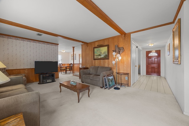 living room featuring ornamental molding, light colored carpet, and beam ceiling