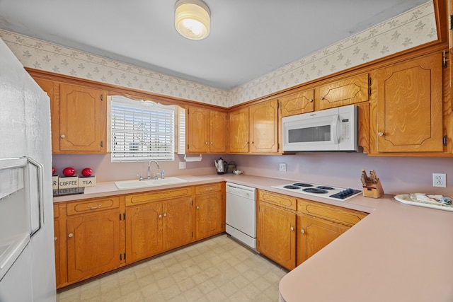 kitchen featuring white appliances and sink