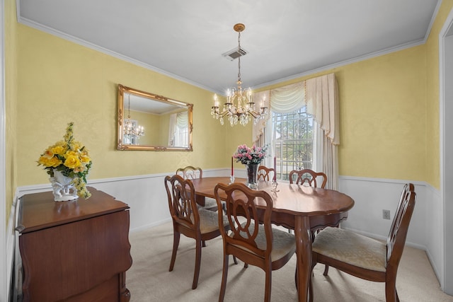 dining space featuring crown molding, a chandelier, and light carpet