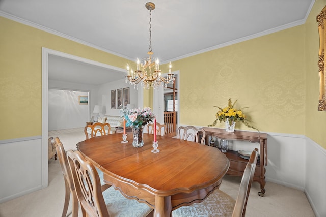 dining area with light carpet, a notable chandelier, and ornamental molding