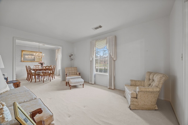 living area with carpet floors and a chandelier