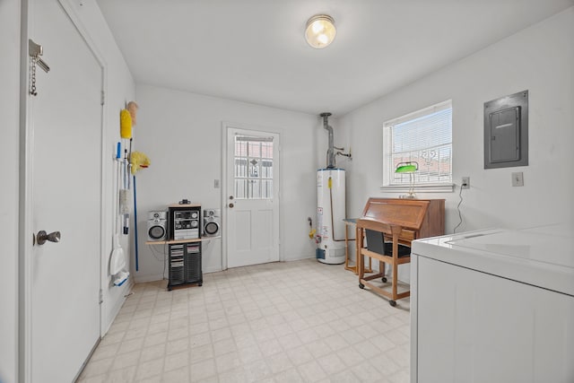 washroom featuring a healthy amount of sunlight, electric panel, washing machine and dryer, and gas water heater