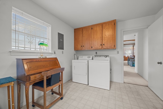 clothes washing area with plenty of natural light, electric panel, cabinets, and washing machine and clothes dryer