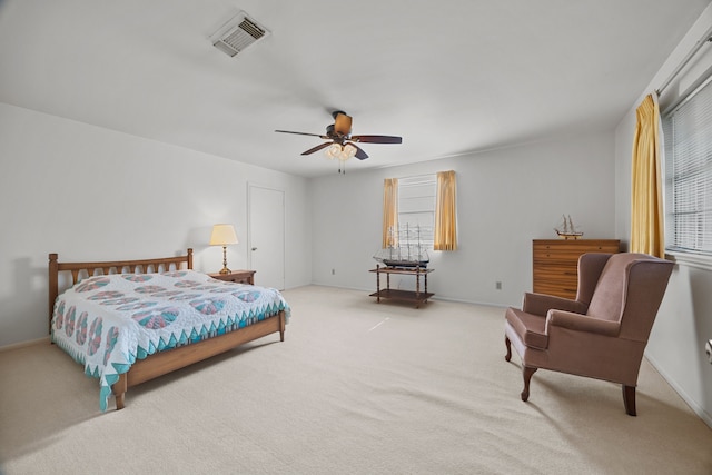 carpeted bedroom with multiple windows and ceiling fan