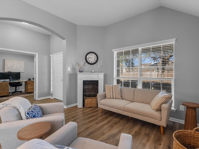 living room with dark wood-type flooring and vaulted ceiling