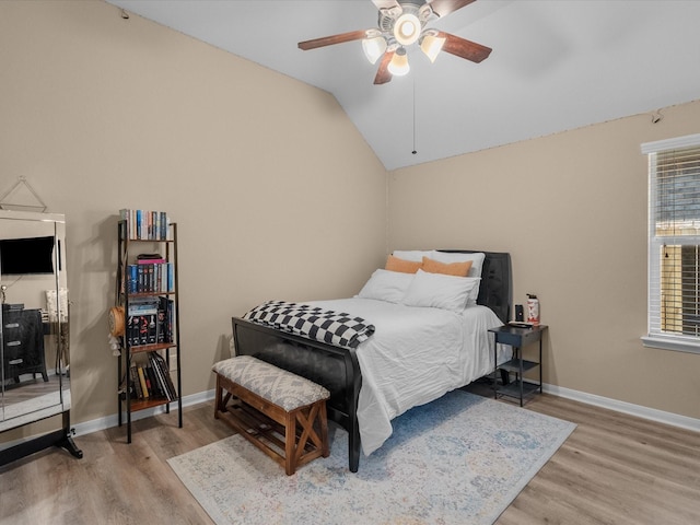 bedroom featuring vaulted ceiling, ceiling fan, and light wood-type flooring