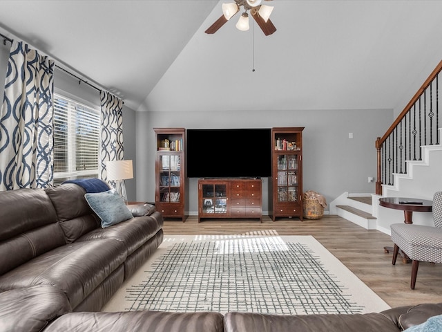 living room with hardwood / wood-style floors, high vaulted ceiling, and ceiling fan