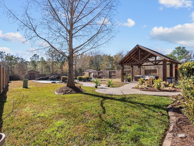 view of yard featuring a pool, a gazebo, a patio area, and a shed