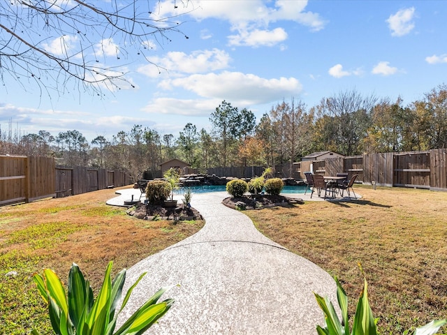 view of yard featuring a swimming pool and a patio