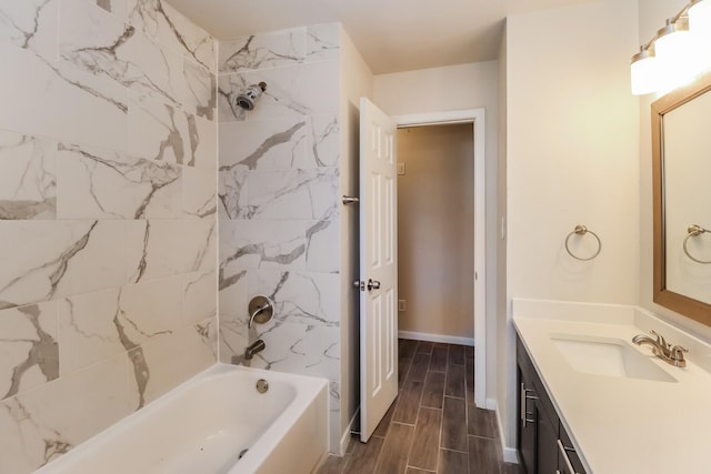 bathroom with tiled shower / bath and vanity