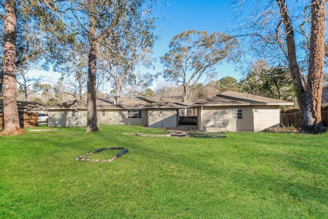 rear view of property with a yard