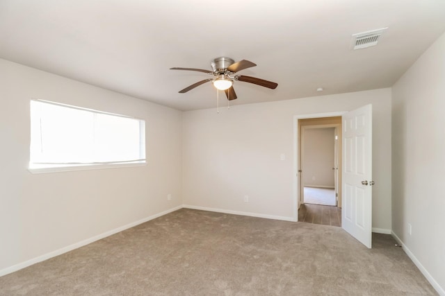 unfurnished room with light carpet and ceiling fan