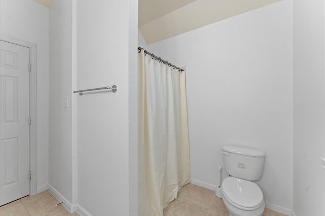 bathroom with tile patterned flooring, toilet, and a shower with shower curtain