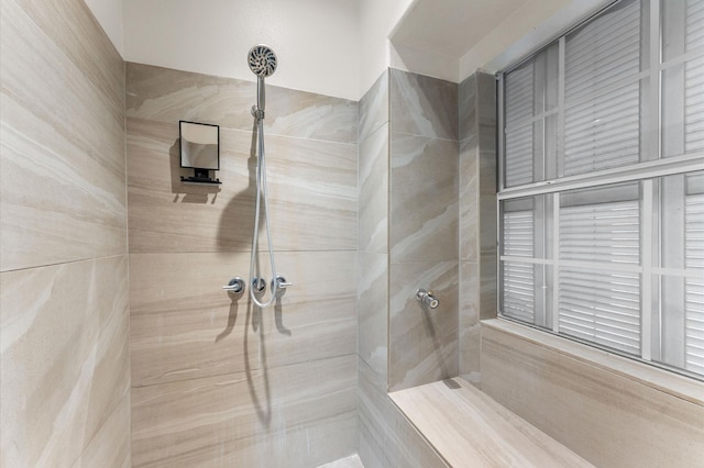 bathroom with a tile shower