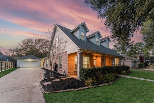 property exterior at dusk with a garage, an outdoor structure, and a lawn