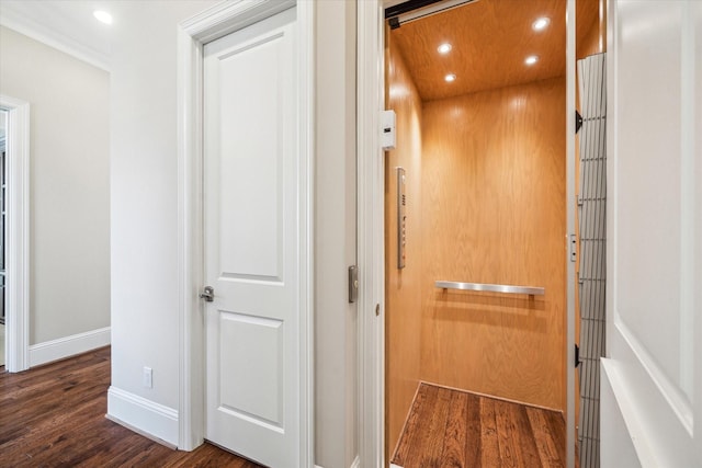 hallway with dark wood-type flooring and elevator