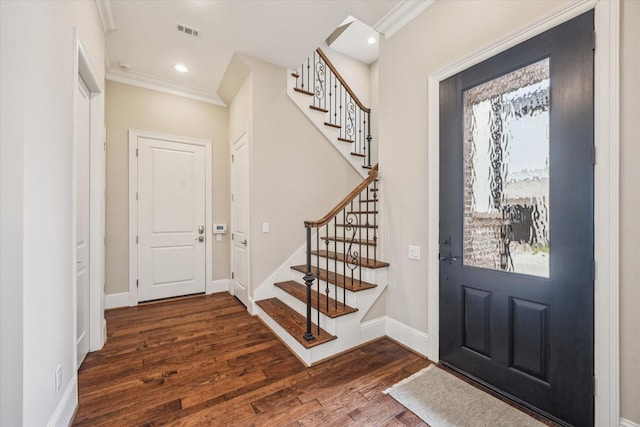 foyer featuring dark wood-type flooring and ornamental molding