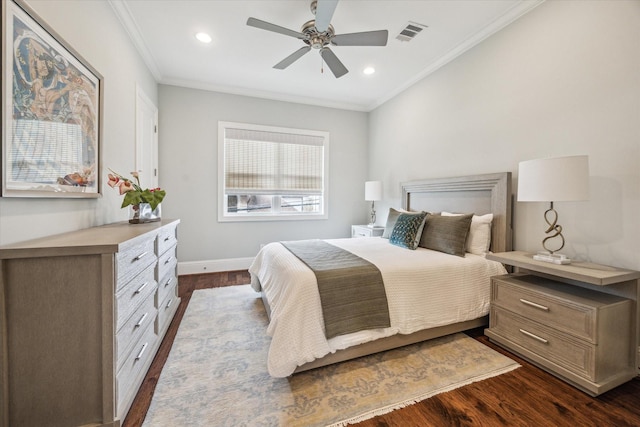 bedroom featuring crown molding, ceiling fan, dark hardwood / wood-style floors, and multiple windows