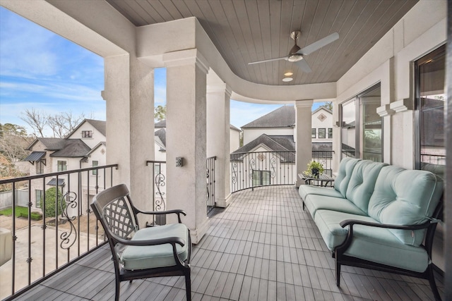 balcony with an outdoor living space and ceiling fan