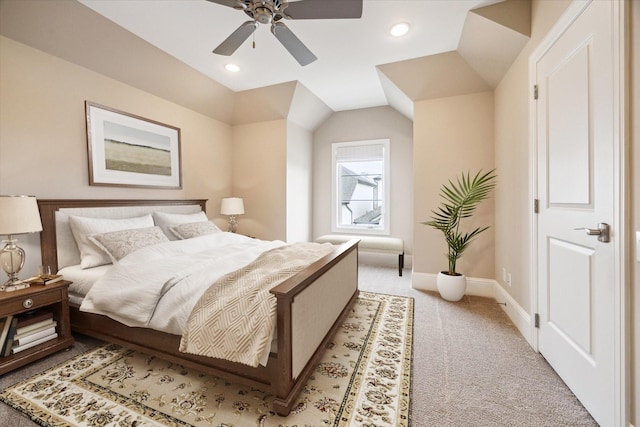 carpeted bedroom with ceiling fan and vaulted ceiling