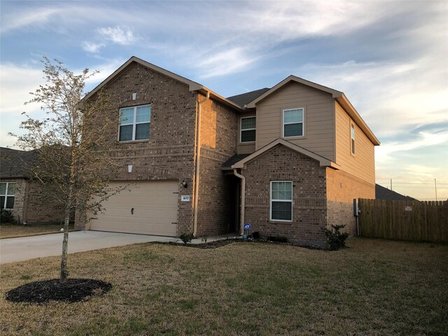 front of property featuring a garage and a lawn