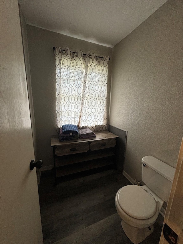 bathroom with toilet and hardwood / wood-style floors