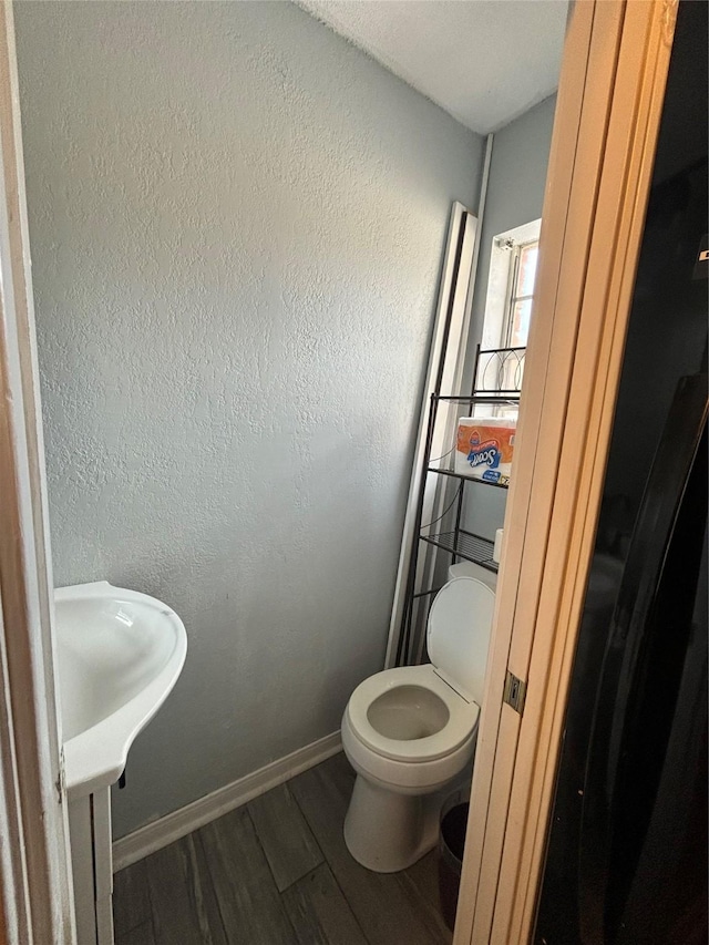 bathroom with hardwood / wood-style flooring, vanity, and toilet