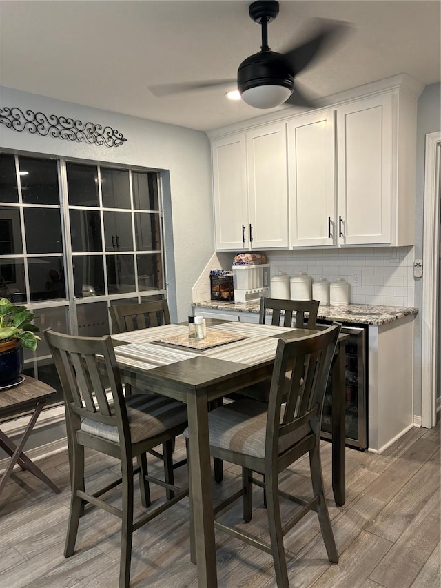 105 Poinciana St, Lake Jackson, TX 77566 - dining area featuring ceiling fan, light wood-style flooring, and wine cooler