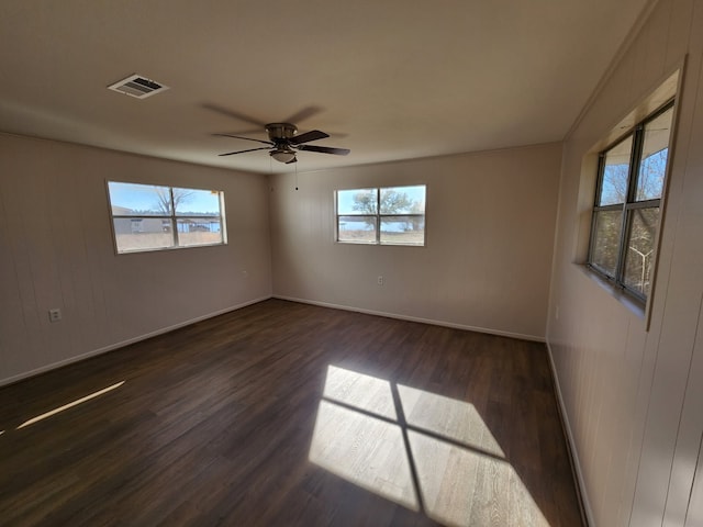 unfurnished room with ceiling fan and dark hardwood / wood-style flooring