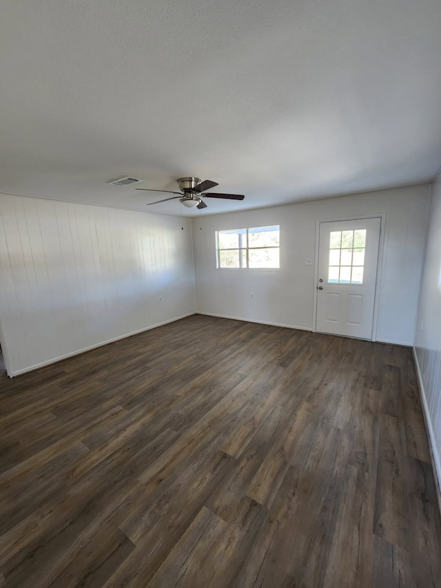 unfurnished room featuring dark hardwood / wood-style flooring and ceiling fan