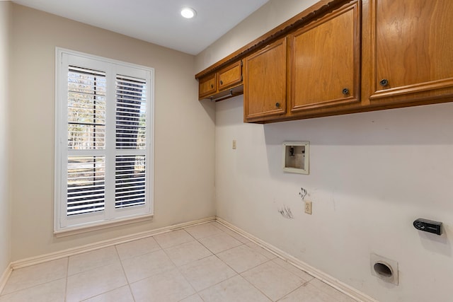 laundry room featuring cabinets, washer hookup, hookup for an electric dryer, and light tile patterned floors