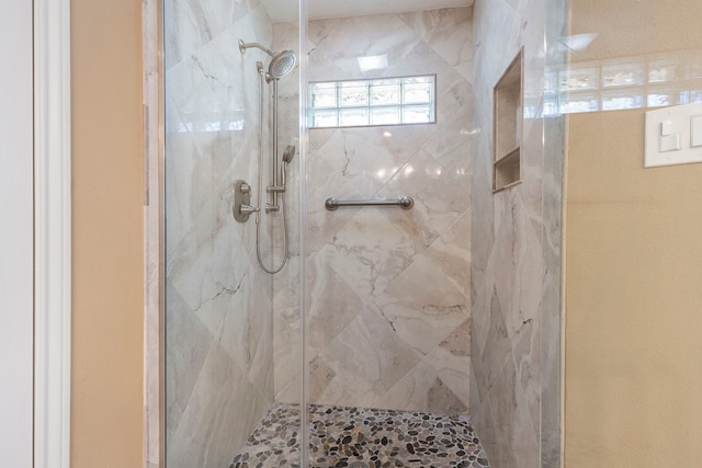 bathroom with a shower with door