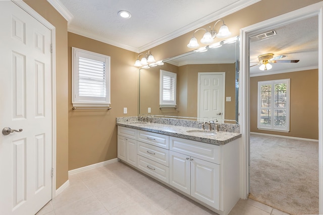 bathroom featuring vanity, a healthy amount of sunlight, and crown molding