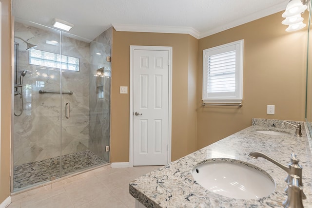 bathroom featuring vanity, crown molding, a wealth of natural light, and a shower with door