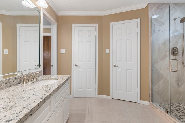 bathroom featuring vanity, tile patterned flooring, crown molding, and a shower with door