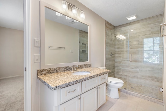 bathroom with tile patterned flooring, vanity, a textured ceiling, toilet, and walk in shower