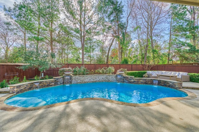 view of pool featuring pool water feature, outdoor lounge area, and a patio area